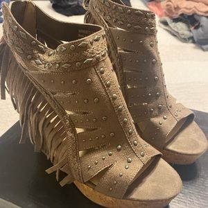 Not rated. Tan suede wedge sandal with fringe detail. Worn once.